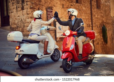 Young Italian Couple On Vespa Scooter. Bikers Couple.
