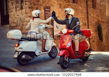 Young Italian Couple on Vespa Scooter. Bikers couple.