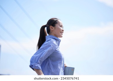Young Japanese business woman commuting