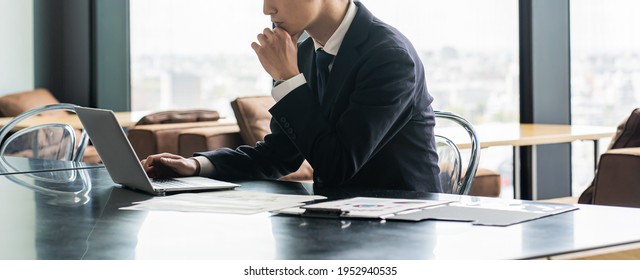 Young Japanese Businessman Working Indoors