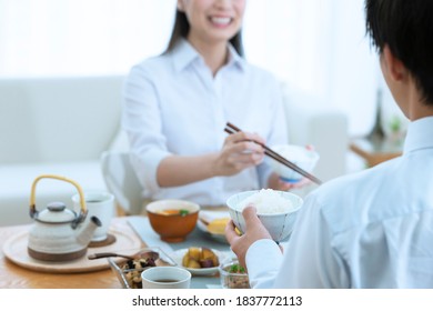 Young Japanese Couple Eating Breakfast