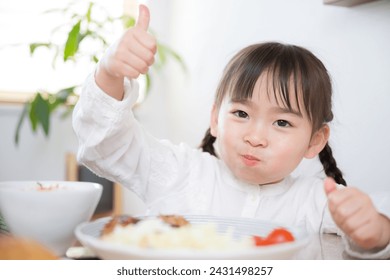 Young Japanese girl eating alone - Powered by Shutterstock