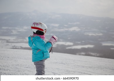 Young Japanese Kid Skiing In Hokkaido.