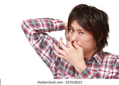 Young Japanese Man Sniffing His Armpit