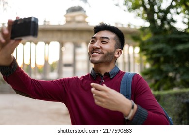 Young Japanese Man Traveling With Photo Camera In The City