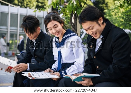 Young japanese students with school uniform bonding outdoors - Group of asian teenagers having fun