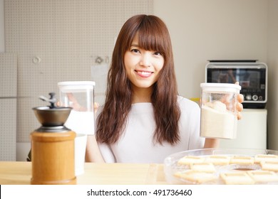 Young Japanese woman cooking foods in a kitchen