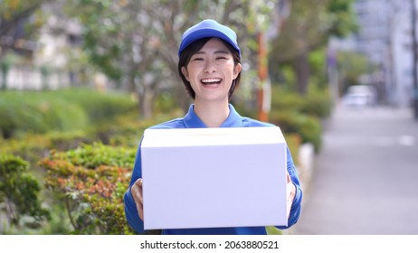 Young Japanese woman delivering luggage