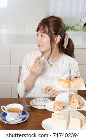 Young Japanese Woman Eating Scone