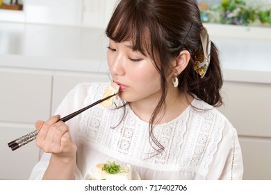 Young Japanese Woman Eating Tofu