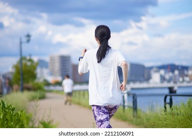Young Japanese woman exercising outdoors - Shutterstock ID 2212106091