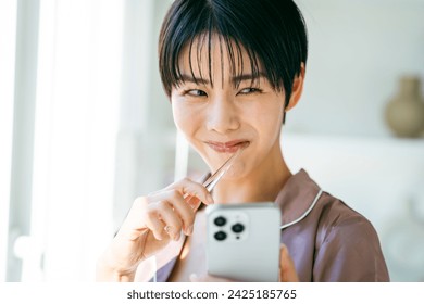 Young Japanese woman getting ready in the morning - Powered by Shutterstock