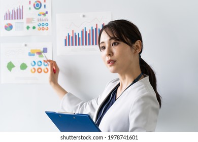 Young Japanese woman giving an explanation - Shutterstock ID 1978741601