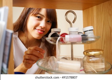 Young Japanese Woman Looking For Some Lost Items At Her Home