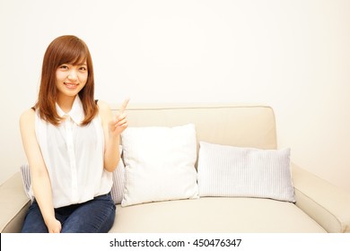 Young Japanese woman pointing something with smile