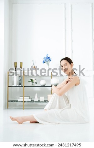 Young Japanese woman satisfied with body care