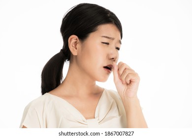 Young Japanese Woman Suffering From Medical Condition While Coughing With Her Hands On Her Mouth