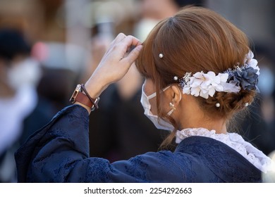 Young Japanese woman wearing a kimono fixing her hair. - Shutterstock ID 2254292663