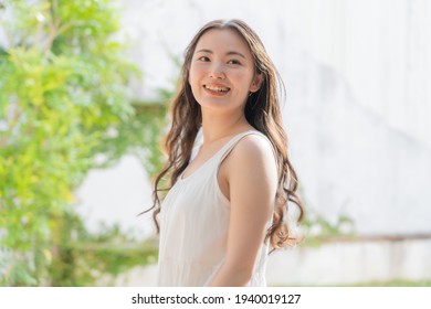 Young Japanese woman in a white dress - Powered by Shutterstock