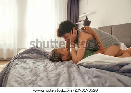 Similar – Image, Stock Photo Young couple in love embracing lying over a bed