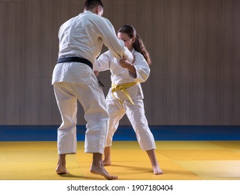 Young Judo Girl Practicing Kumikata With Adult Opponent