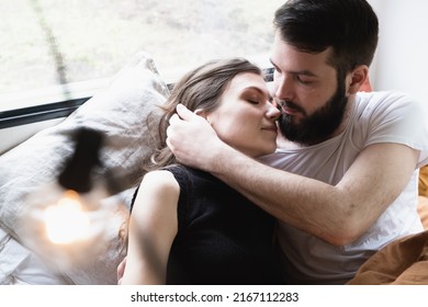 Young Just Married Couple Is Traveling In Travel Van. Romantic Atmosphere Of Relaxation. Road Trip Around Country For Weekend. Caucasian Man And Woman Lying In Bedroom In Camper. Millennial Generation