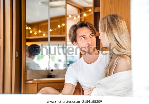 Young just married couple\
traveling in camper,house on wheels,trailer,motor home.Love\
romantic road travel,freedom life. Small bed,bedroom in\
van.Wanderlust vacation,weekend. Girl,guy,happy\
adventure.