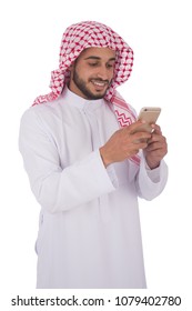 Young Khaleeji Man Holding His Phone Chatting And Smiling, Isolated On A White Background.