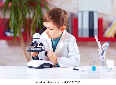 Young Kid Conducts Experiment With Microscope In School Lab