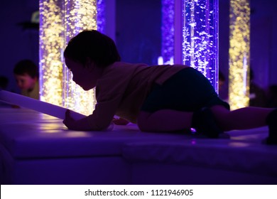 Young Kid Exploring A Multi Sensory Space - Snoezelen Concept