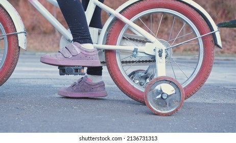 Young Kid Learning To Ride a Bike without Support Stabilizer Wheels Left Behind