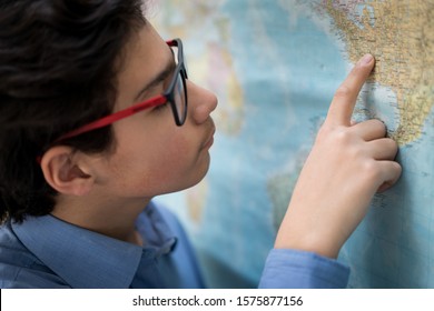 Young Kid In School Finding Place On Map