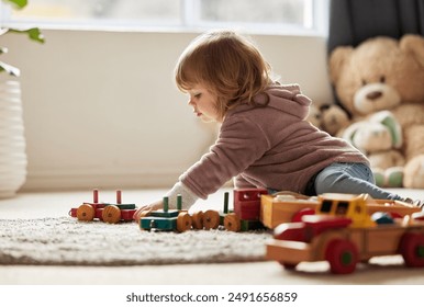 Young kid, toys and play in bedroom for development or learning, child in home for motor skills. Baby, house and relax game with wood cars for education or creativity, wellness or cognitive growth - Powered by Shutterstock