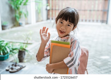 Young Kid Waving Goodbye Before Leaving To School In The Morning