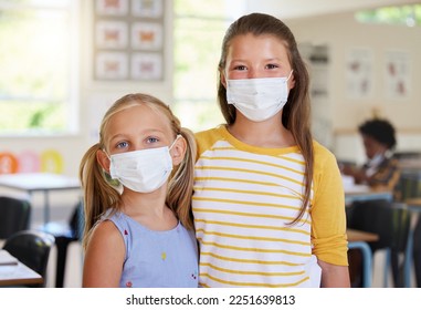 Young kids learning in classroom, after covid pandemic, wearing face masks together in school. Portrait of little girl students, waiting for their education lesson to begin, with their friends - Shutterstock ID 2251639813