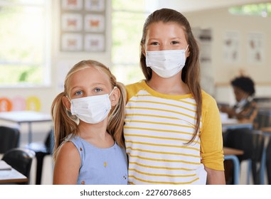 Young kids learning in classroom, after covid pandemic, wearing face masks together in school. Portrait of little girl students, waiting for their education lesson to begin, with their friends - Shutterstock ID 2276078685