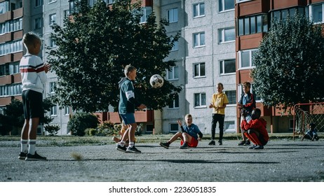 Young Kids Playing with Ball in the Neighborhood. Boy Practicing, Doing Kick-Ups. Teenager Dreaming of Becoming a Professional Football Player. Friends Cheering. Cold Desaturated Color Grading. - Powered by Shutterstock
