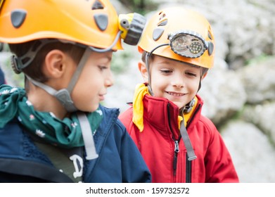 Young Kids Wearing Helmet For Cave Exploration. 