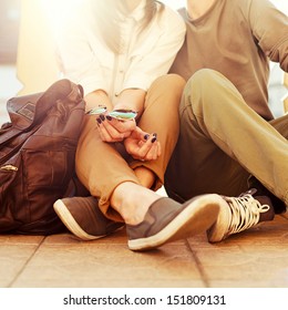 Young kissing happy couple in love sitting on the ground in summer sunny evening - Shutterstock ID 151809131