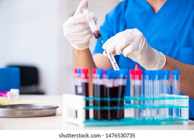 Young lab assistant testing blood samples in hospital 