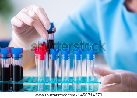 Young lab assistant testing blood samples in hospital