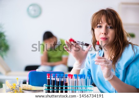 Young lab assistant testing blood samples in hospital 