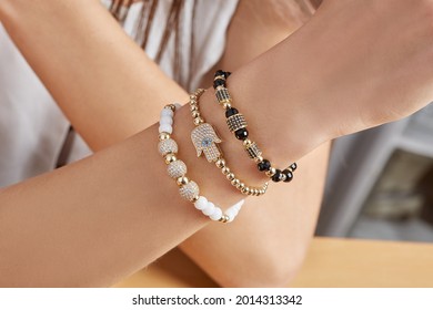 Young ladies hand resting on hip and showing off her stacked bohemian style bracelet set.