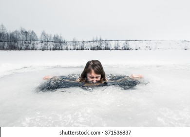 Young lady bathing in the ice hole