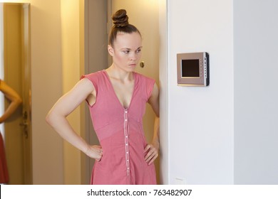 Young lady between 30 and 40 years old and intercom - Shutterstock ID 763482907