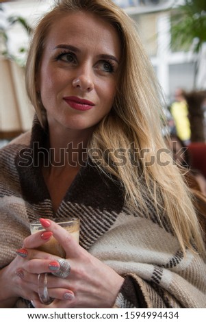 Similar – Happy girl using a smart phone sitting on a couch at home