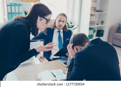 Young Lady Chief Boss In Glasses Wearing Jacket Having Quarrel With Employees About Overdue Financial Report At Work Place, Work Station, Businesspeople. Bullying Concept