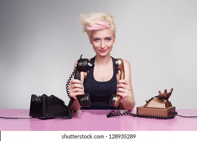 young lady with crazy hair holding handset to each other and having fun
