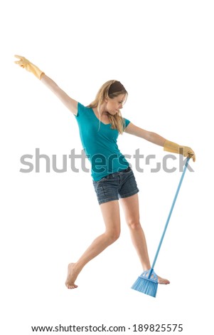 Young lady dancing with the broom