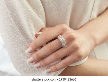 Young Lady With A Diamond Ring In Her Hand. Lovely Background.